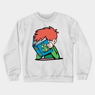 boy with his head in a book reads a fairy tale about a frog prince Crewneck Sweatshirt